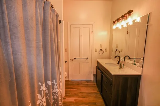 a front view of a house with a yard and trees