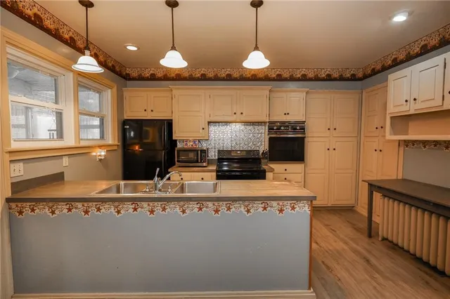 a view of empty room with wooden floor and fireplace