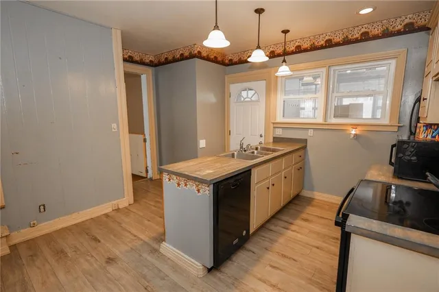 a view of a livingroom with a fireplace and glass door