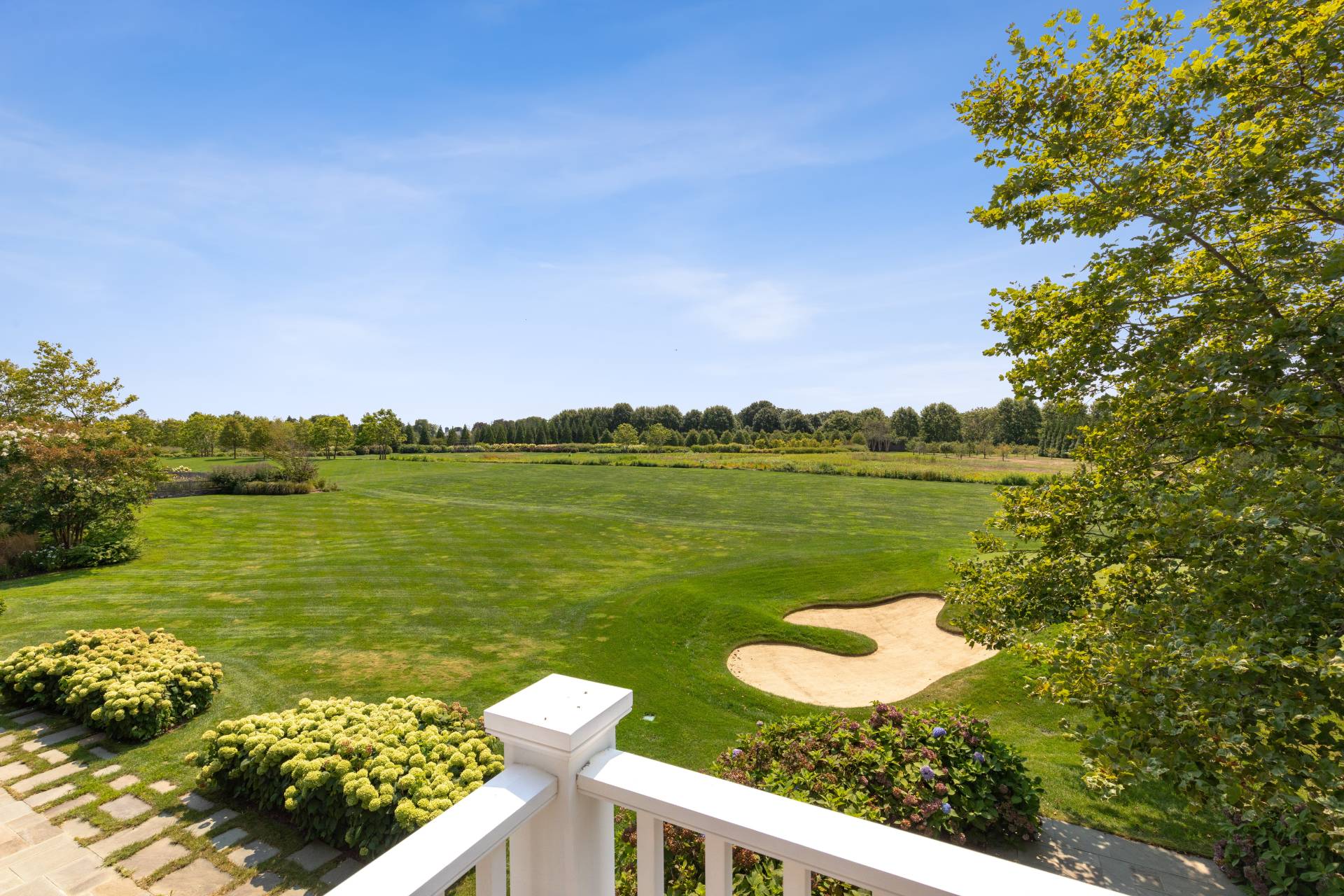 461 Ocean Road Bridgehampton, NY 11932 - Photo 1 of 29 a view of a lake with a house in the background