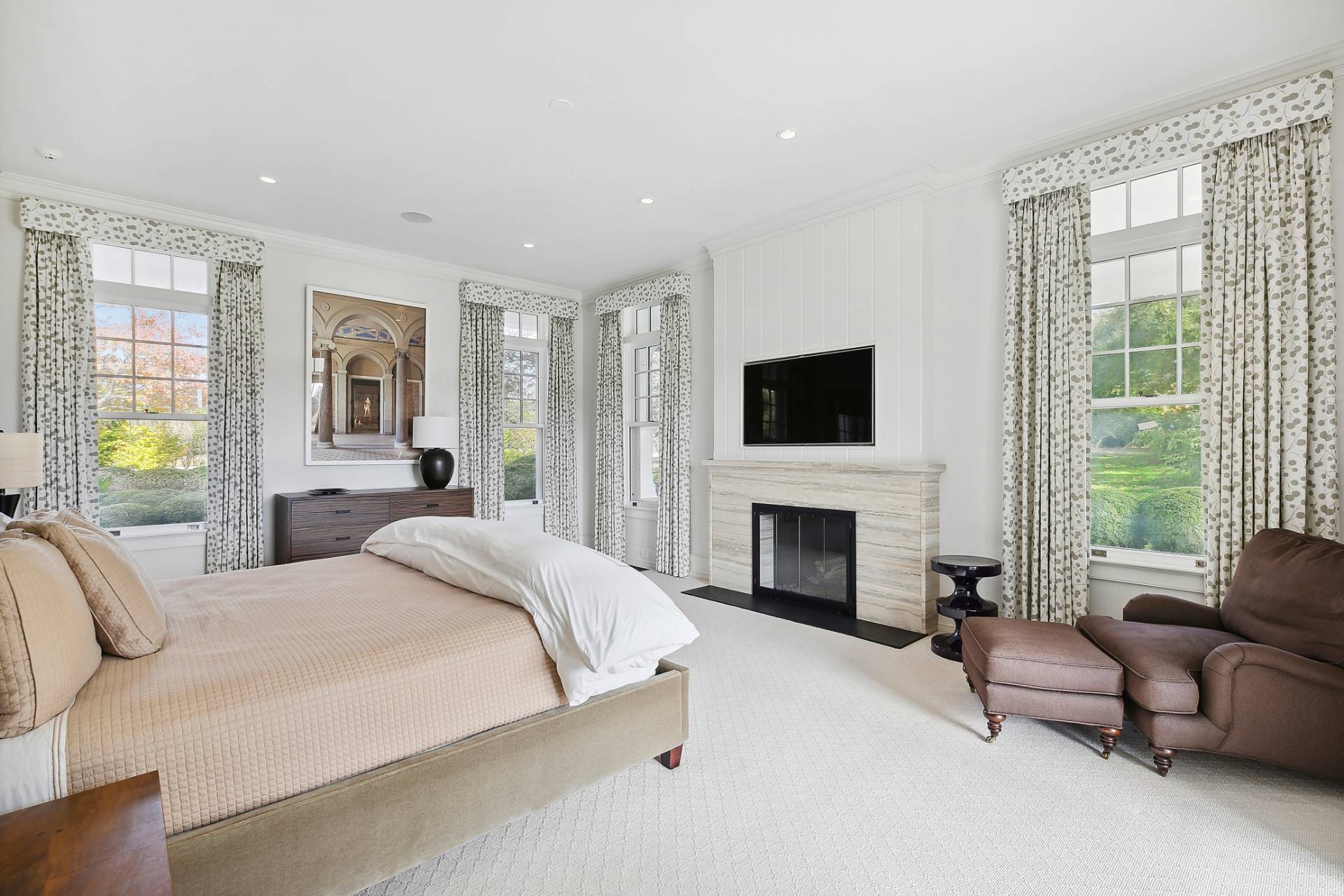 461 Ocean Road Bridgehampton, NY 11932 - Photo 12 of 29 a spacious bedroom with a balcony a bed furniture and a flat screen tv