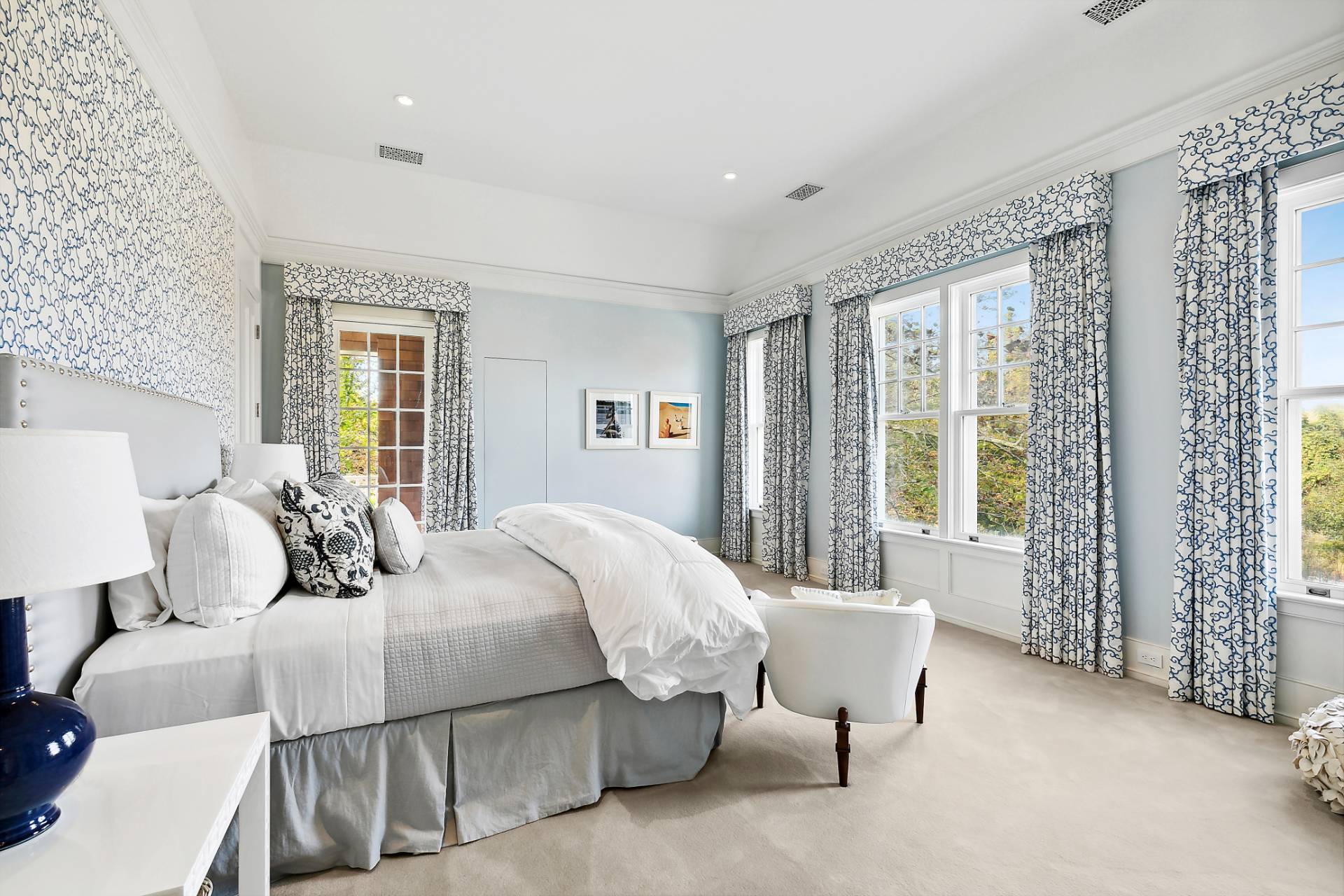 461 Ocean Road Bridgehampton, NY 11932 - Photo 16 of 29 a bedroom with a bed and glass window