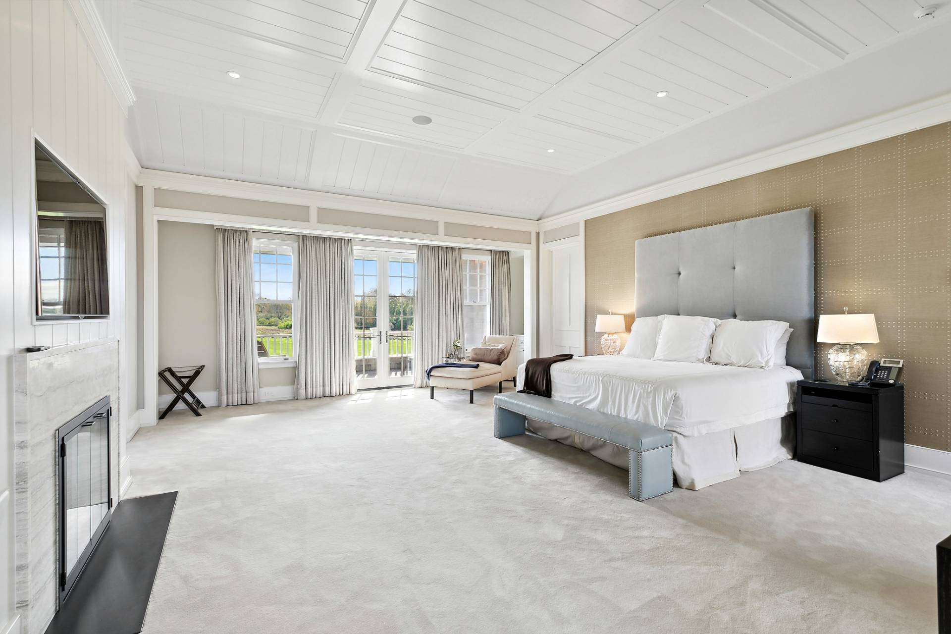 461 Ocean Road Bridgehampton, NY 11932 - Photo 18 of 29 a spacious bedroom with a bed a couch and large window