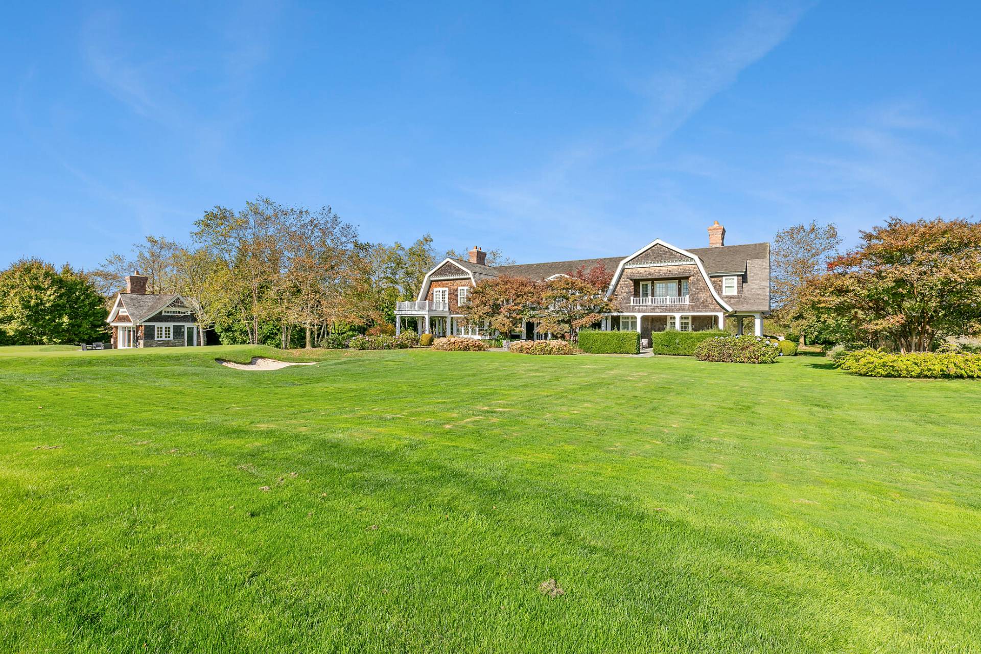 461 Ocean Road Bridgehampton, NY 11932 - Photo 28 of 29 a view of a green field with house in the background