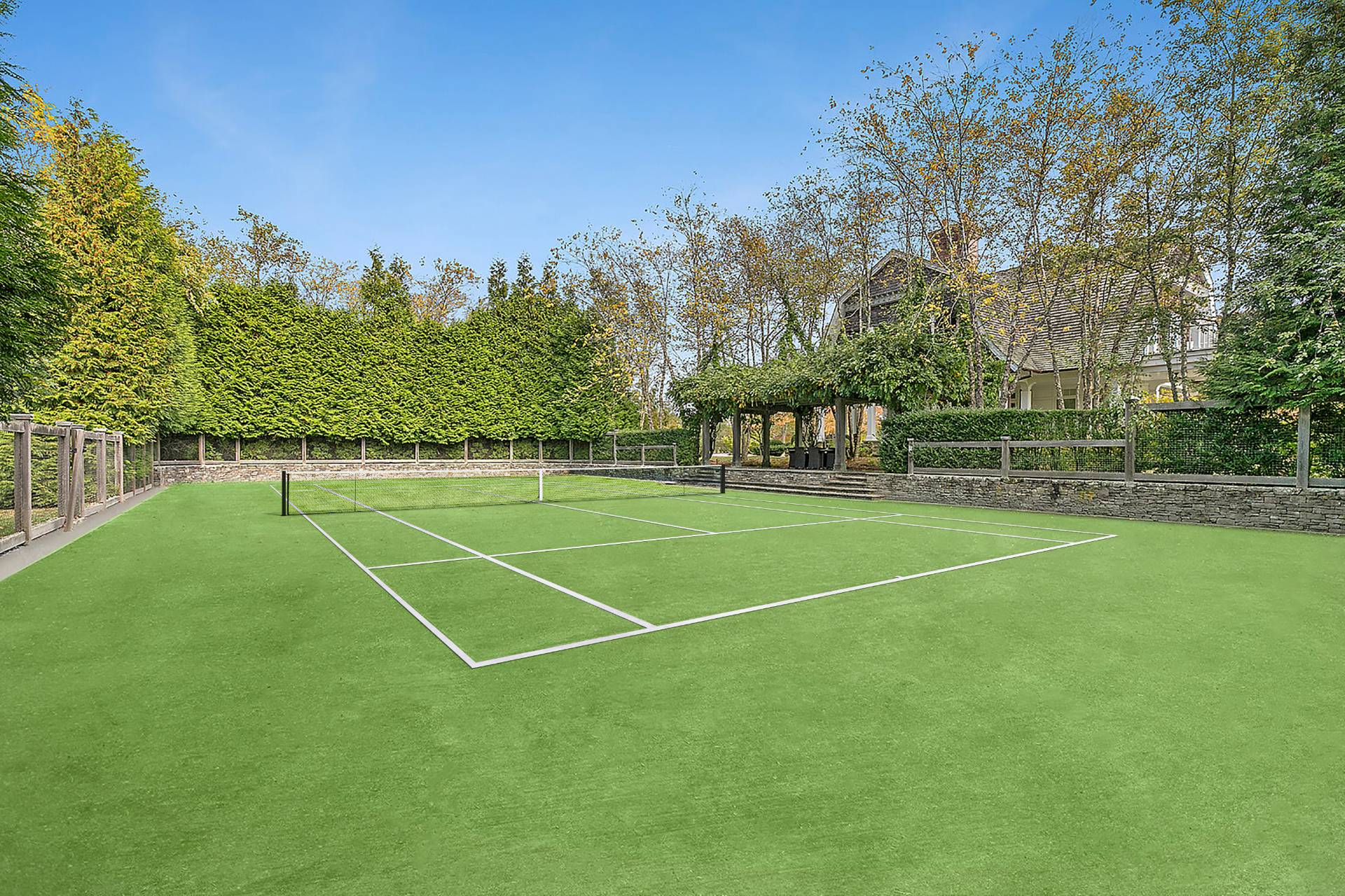 461 Ocean Road Bridgehampton, NY 11932 - Photo 4 of 29 a view of a tennis ground with large trees