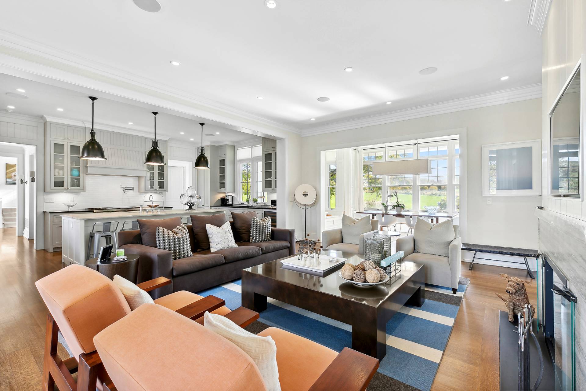 461 Ocean Road Bridgehampton, NY 11932 - Photo 6 of 29 a living room with furniture kitchen view and a wooden floor