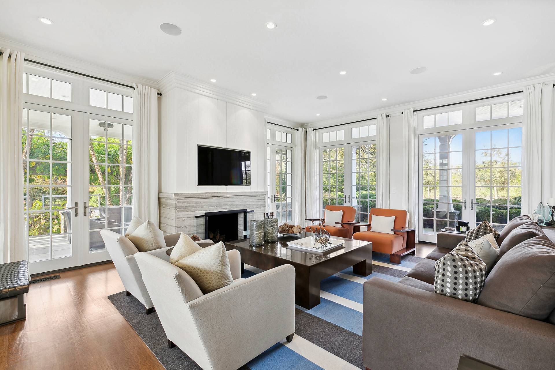 461 Ocean Road Bridgehampton, NY 11932 - Photo 8 of 29 a living room with fireplace furniture and a flat screen tv