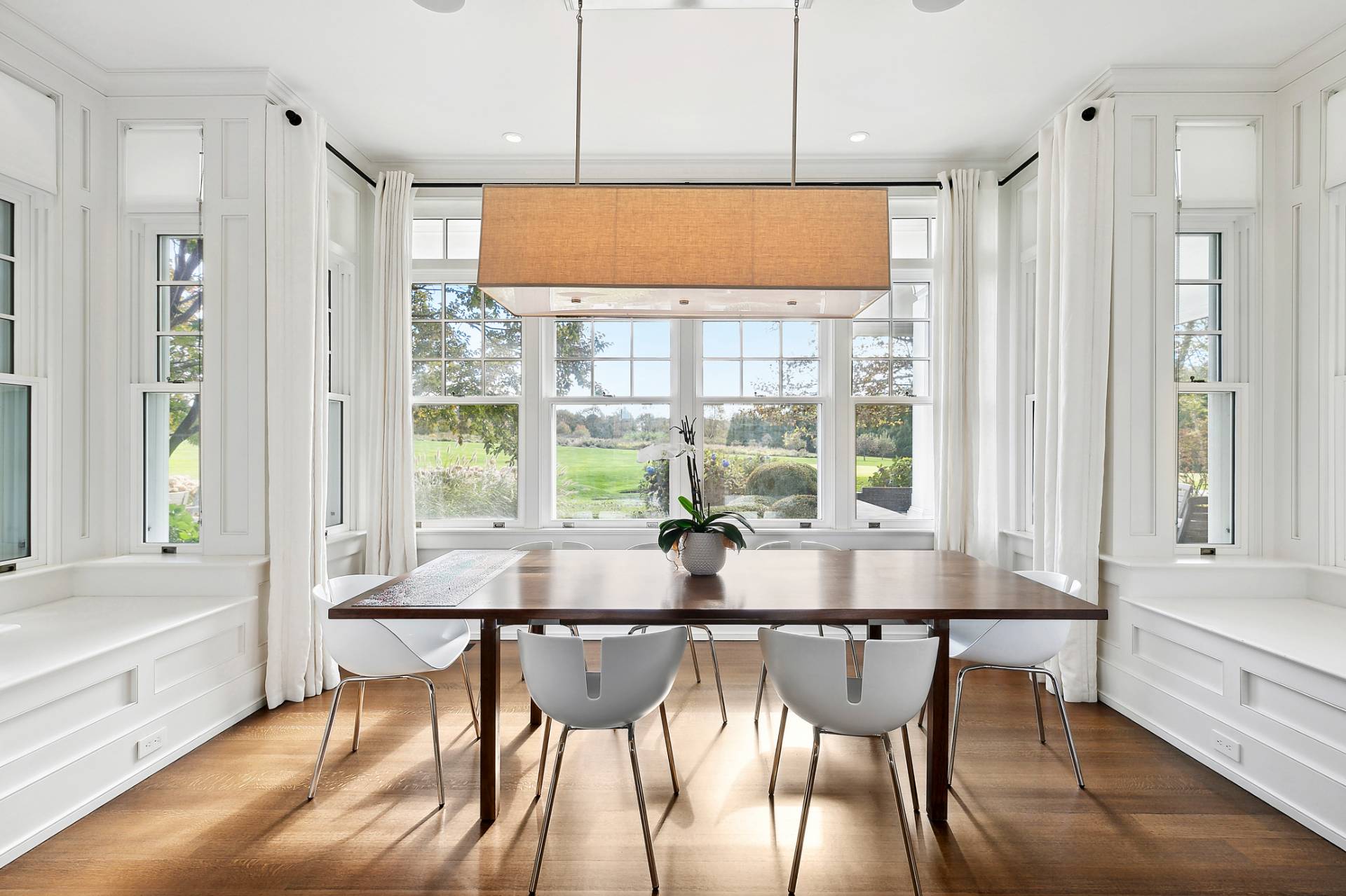 461 Ocean Road Bridgehampton, NY 11932 - Photo 9 of 29 a dining room with furniture a large window and wooden floor