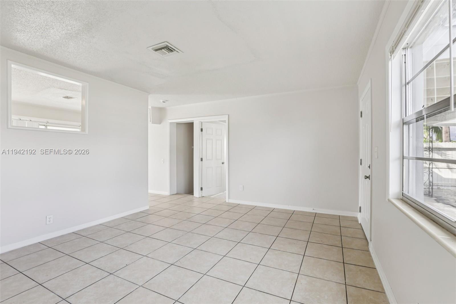 3209 Scanlan Avenue Lake Worth, FL 33461 - Photo 11 of 41 a view of an empty room and window