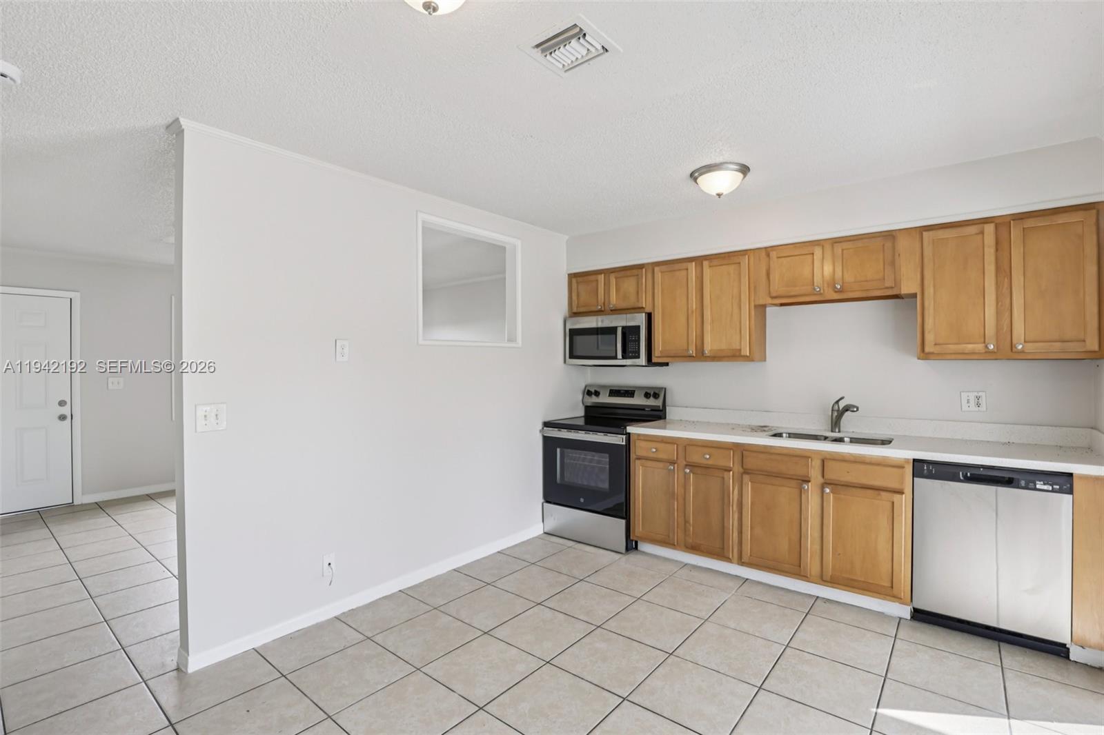 3209 Scanlan Avenue Lake Worth, FL 33461 - Photo 14 of 41 a kitchen with stainless steel appliances granite countertop a sink and cabinets