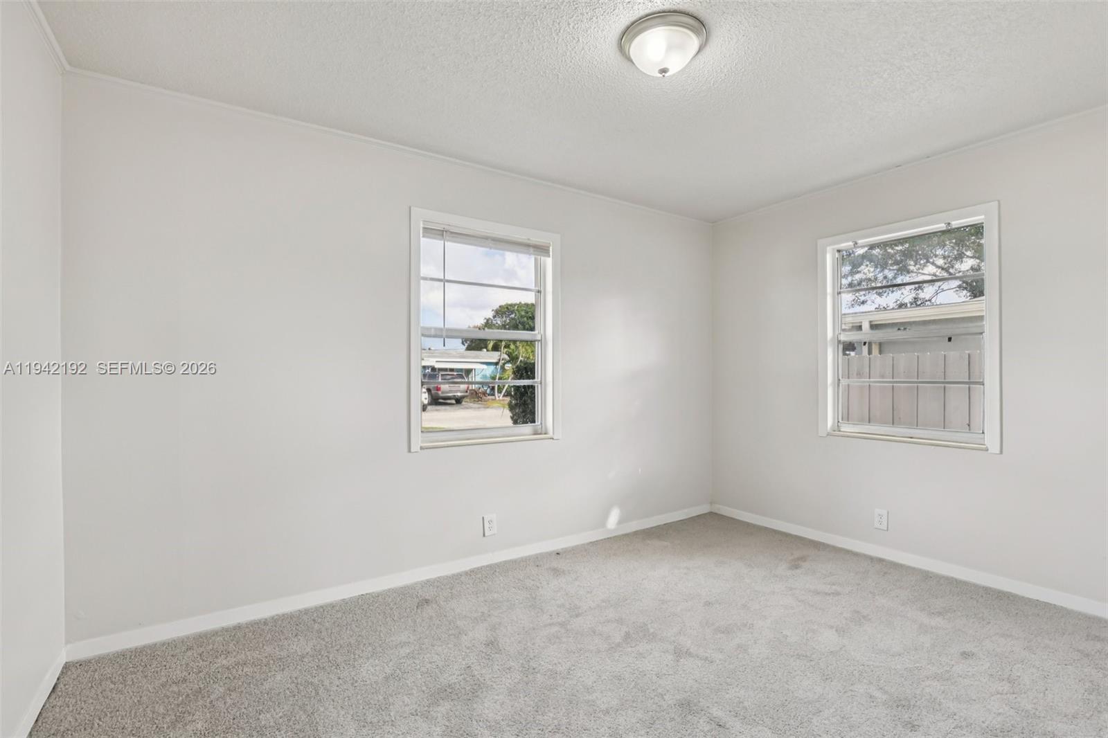 3209 Scanlan Avenue Lake Worth, FL 33461 - Photo 18 of 41 an empty room with windows
