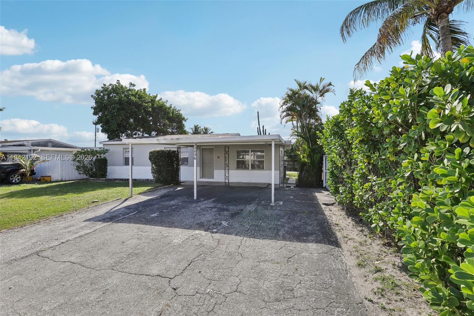 3209 Scanlan Avenue Lake Worth, FL 33461 - Photo 2 of 41 a front view of house with yard and green space