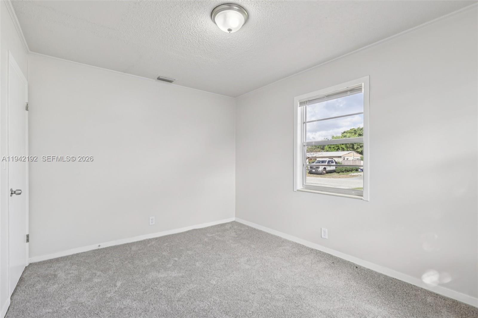 3209 Scanlan Avenue Lake Worth, FL 33461 - Photo 21 of 41 an empty room with windows