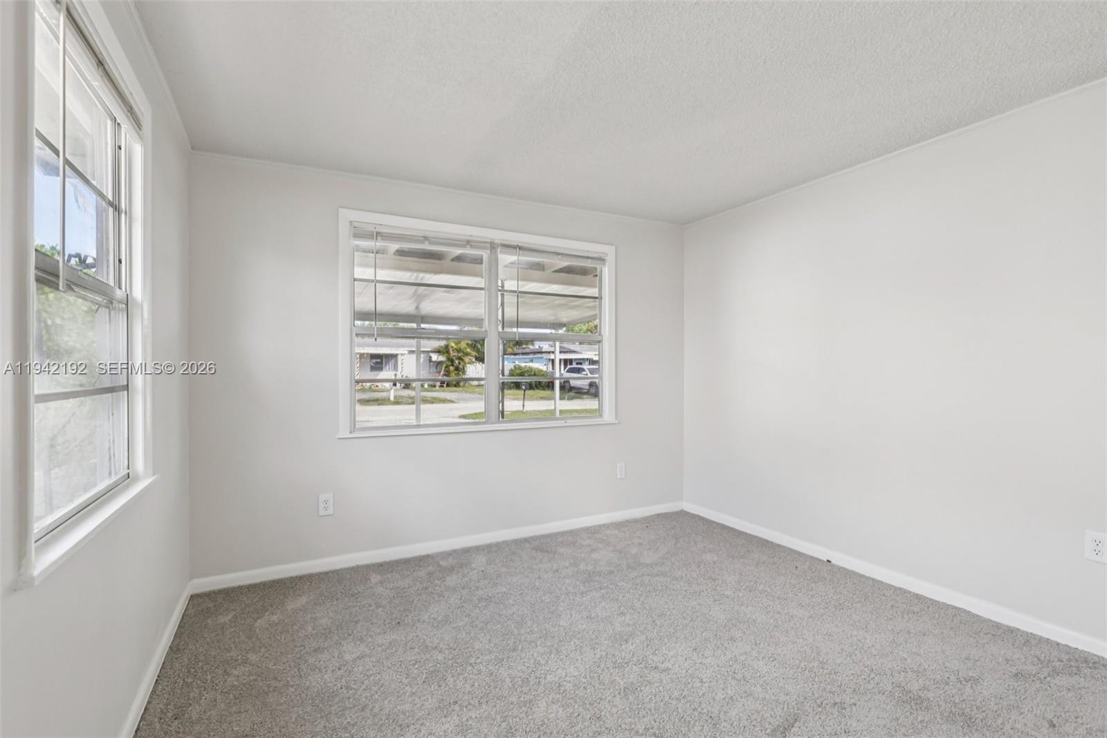 3209 Scanlan Avenue Lake Worth, FL 33461 - Photo 23 of 41 an empty room with windows