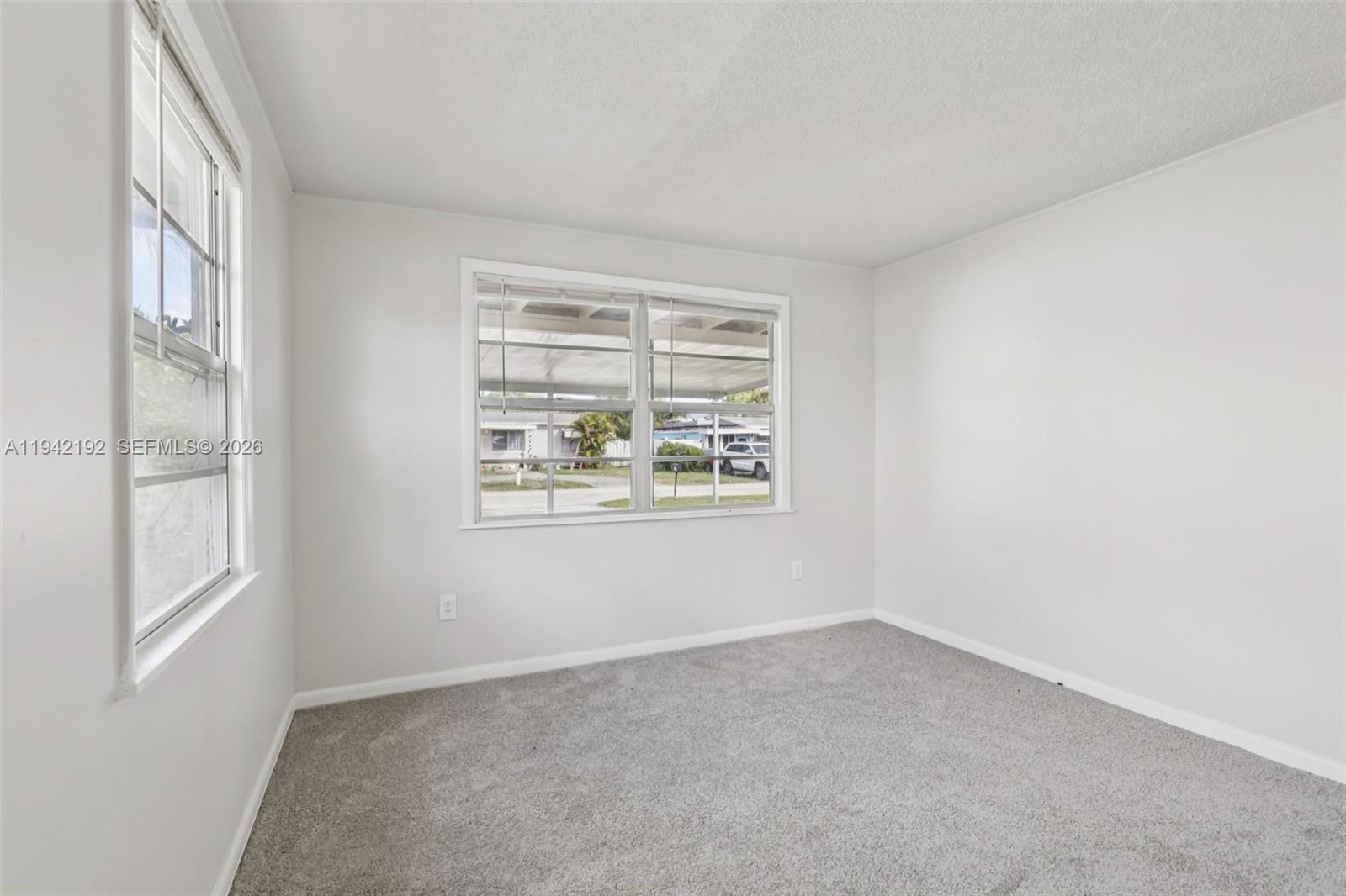 3209 Scanlan Avenue Lake Worth, FL 33461 - Photo 24 of 41 an empty room with windows