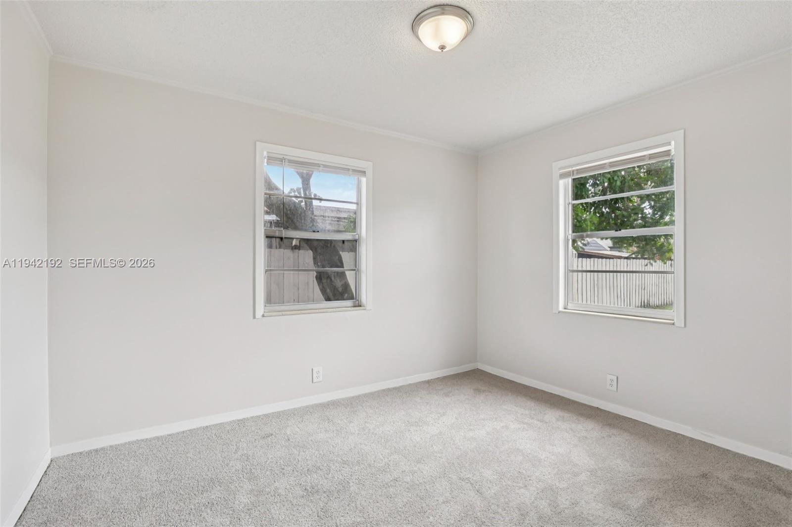 3209 Scanlan Avenue Lake Worth, FL 33461 - Photo 28 of 41 an empty room with windows