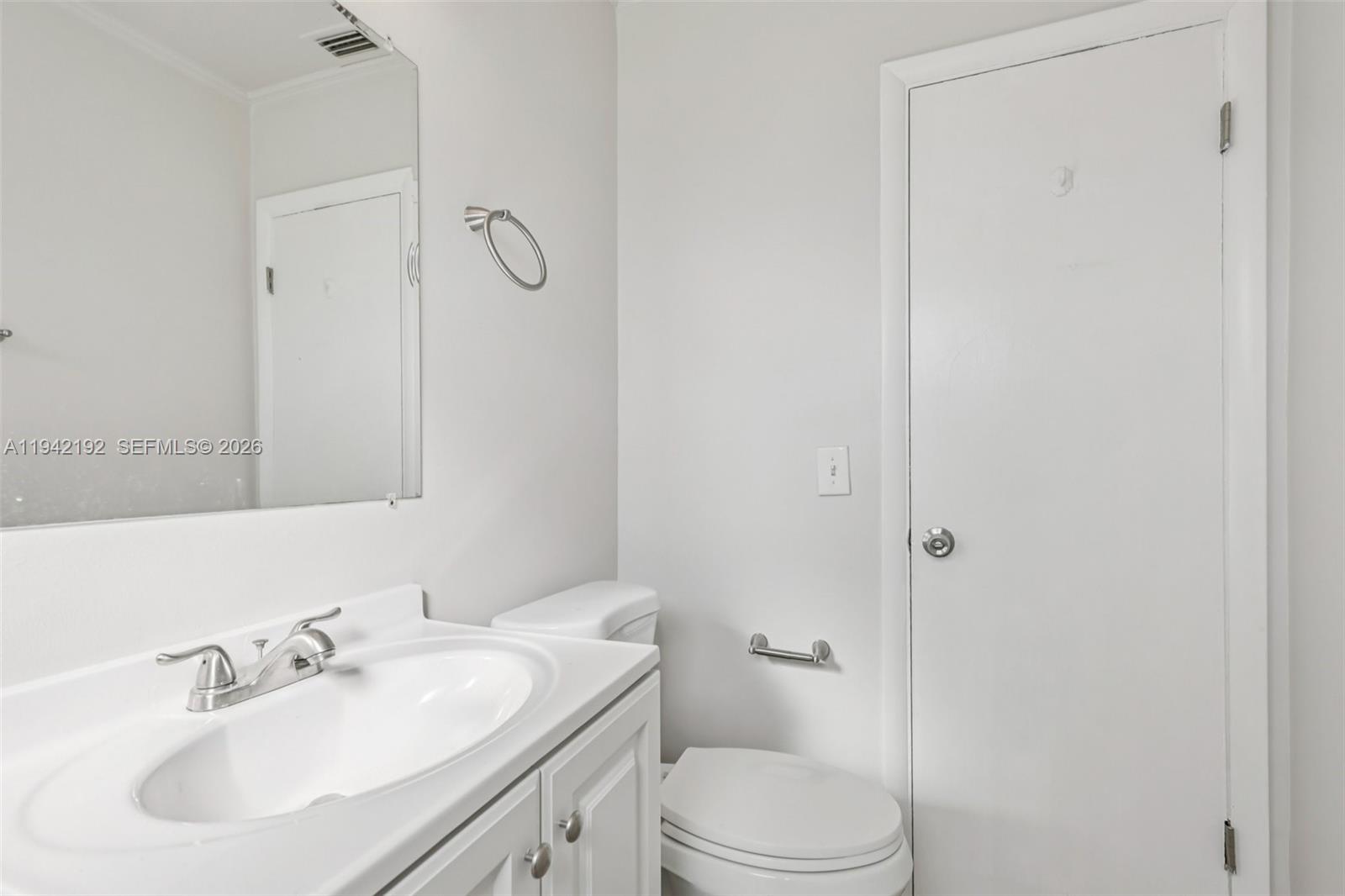 3209 Scanlan Avenue Lake Worth, FL 33461 - Photo 33 of 41 a bathroom with a sink toilet and vanity