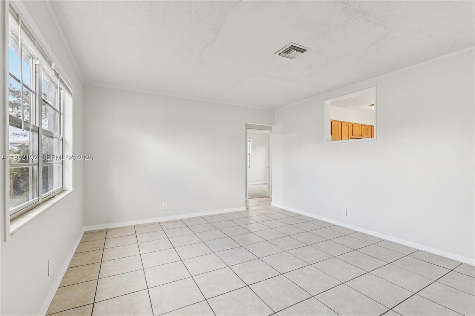 3209 Scanlan Avenue Lake Worth, FL 33461 - Photo 5 of 41 a view of an empty room with a window