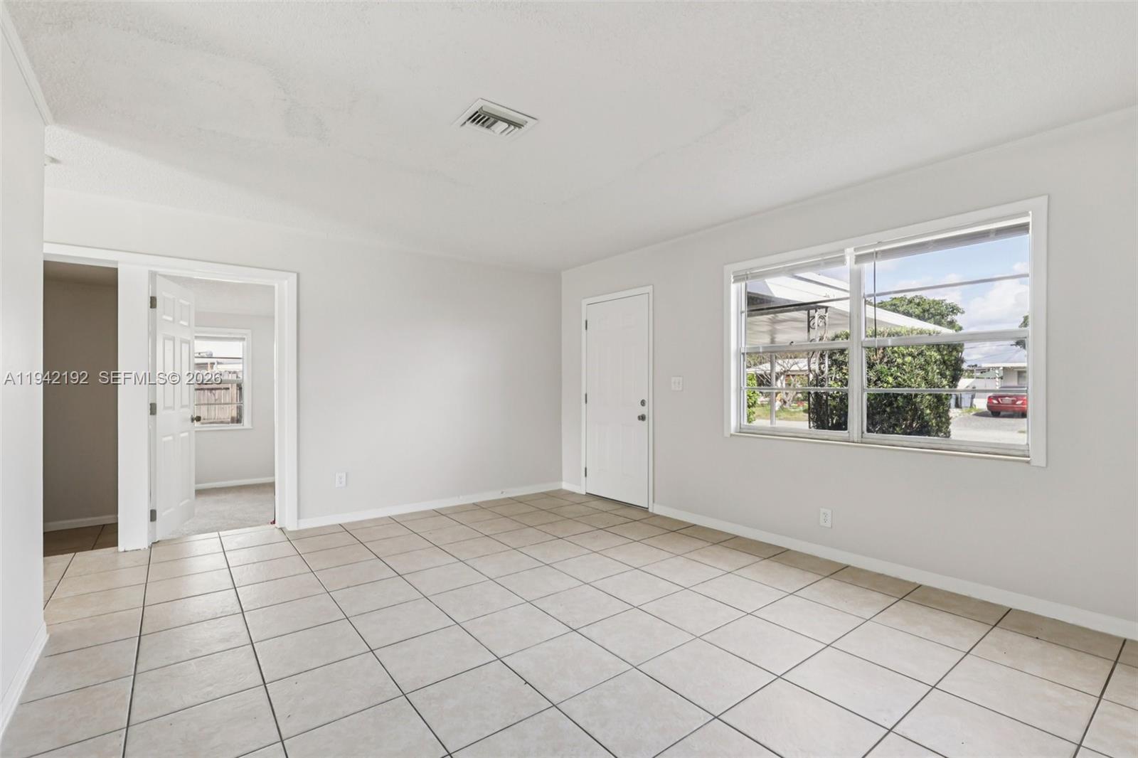 3209 Scanlan Avenue Lake Worth, FL 33461 - Photo 9 of 41 a view of an empty room and window