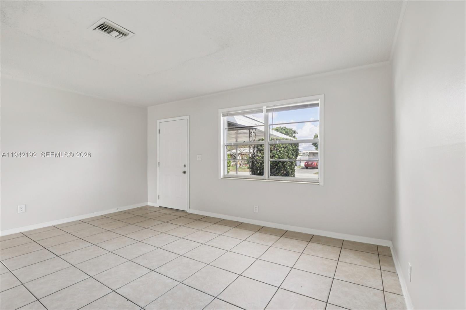 3209 Scanlan Avenue Lake Worth, FL 33461 - Photo 10 of 41 a view of an empty room with a window