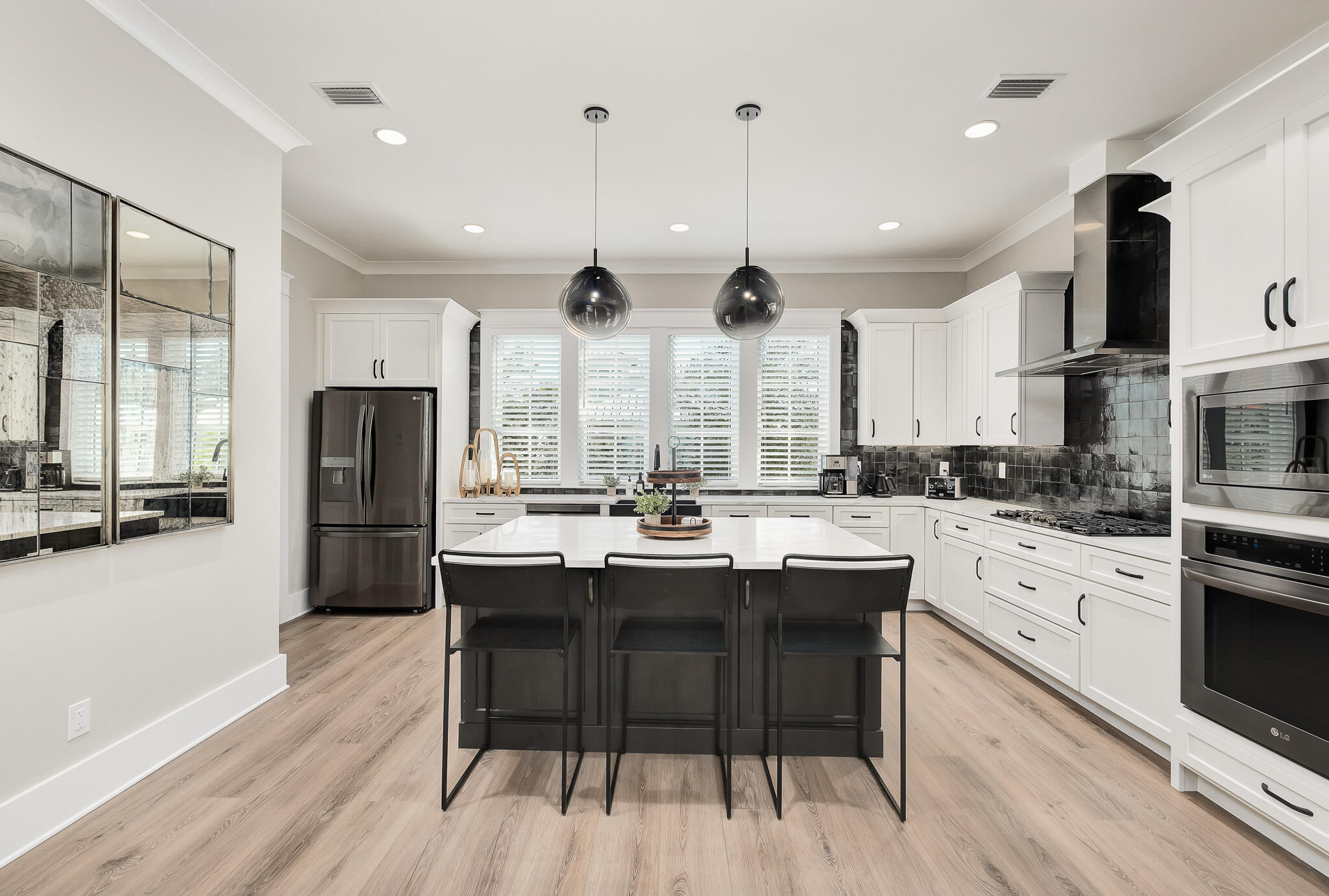 107 Grande Pointe Dr Inlet Beach Inlet Beach, FL 32461 - Photo 14 of 78 a kitchen with stainless steel appliances granite countertop a stove a sink a refrigerator and a dining table with wooden floor