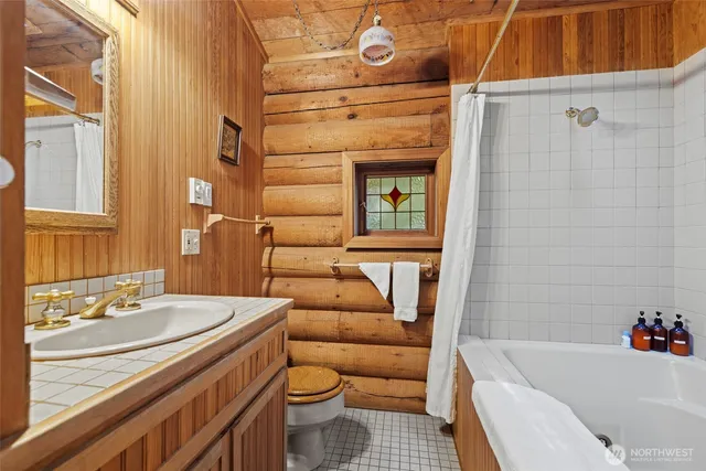 a bathroom with a sink a toilet and bathtub