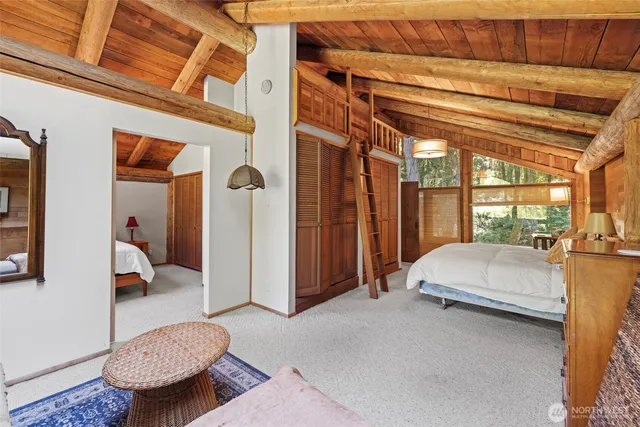 a living room with a bed and walk in closet