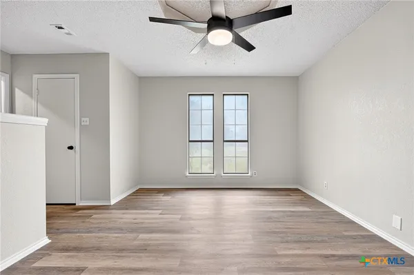 wooden floor in an empty room with a window