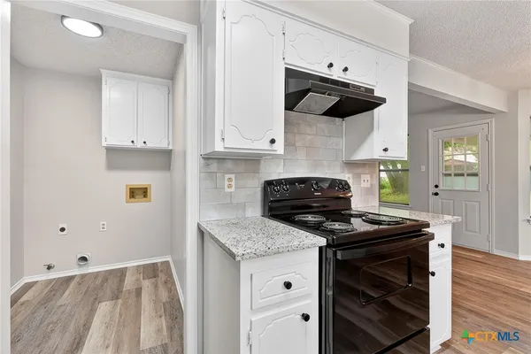 a kitchen with stainless steel appliances granite countertop a stove a sink and a granite counter tops