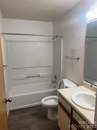 a bathroom with a granite countertop toilet sink and shower