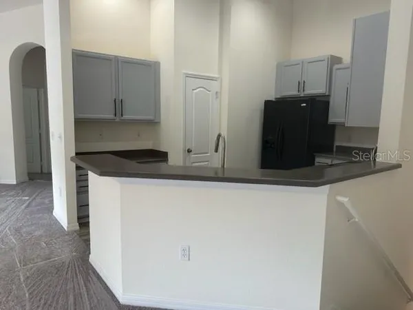 a kitchen with stainless steel appliances granite countertop a refrigerator and a stove