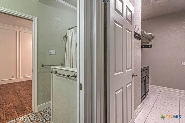 a bathroom with a granite countertop sink a toilet and a mirror