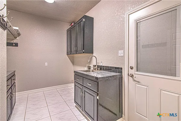 a close view of a sink and cabinets