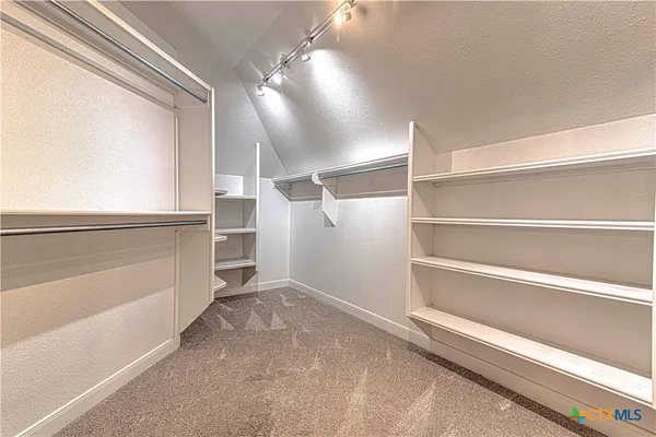 a view of a hallway with wooden floor and closet