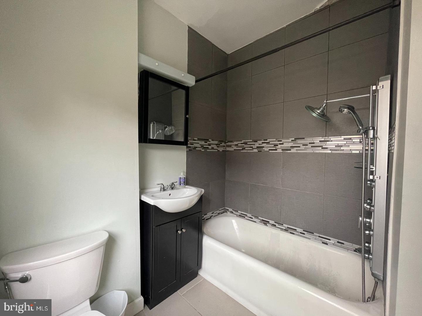 1324 Locust Street, Unit 727 Philadelphia, PA 19107 - Photo 7 of 7 a bathroom with a sink a toilet and shower