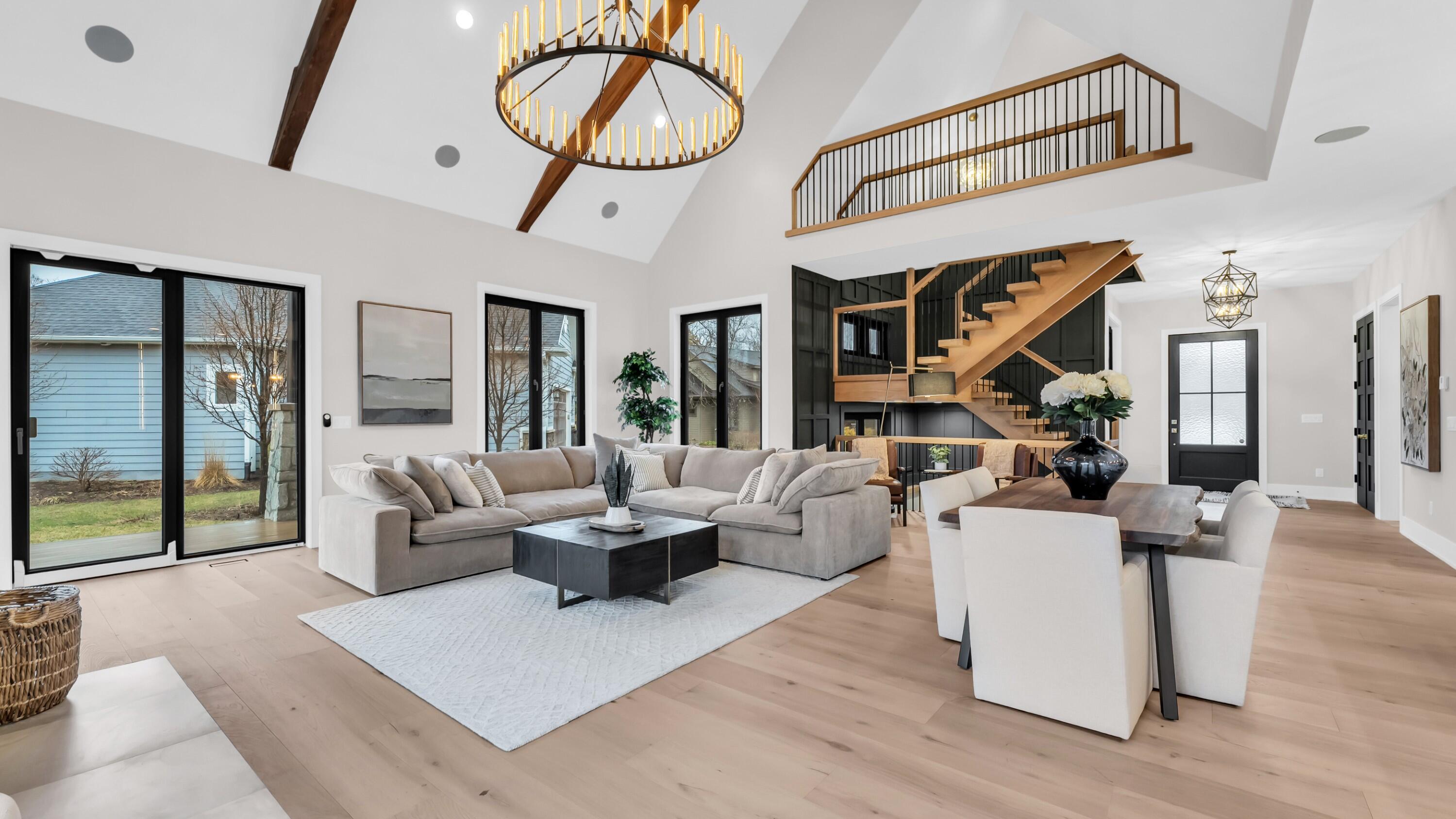 525 Maple Street Lake Geneva, WI 53147 - Photo 2 of 70 The stunning spacious great room with cathedral ceiling looking back into the living space showing the staircase and loft area.