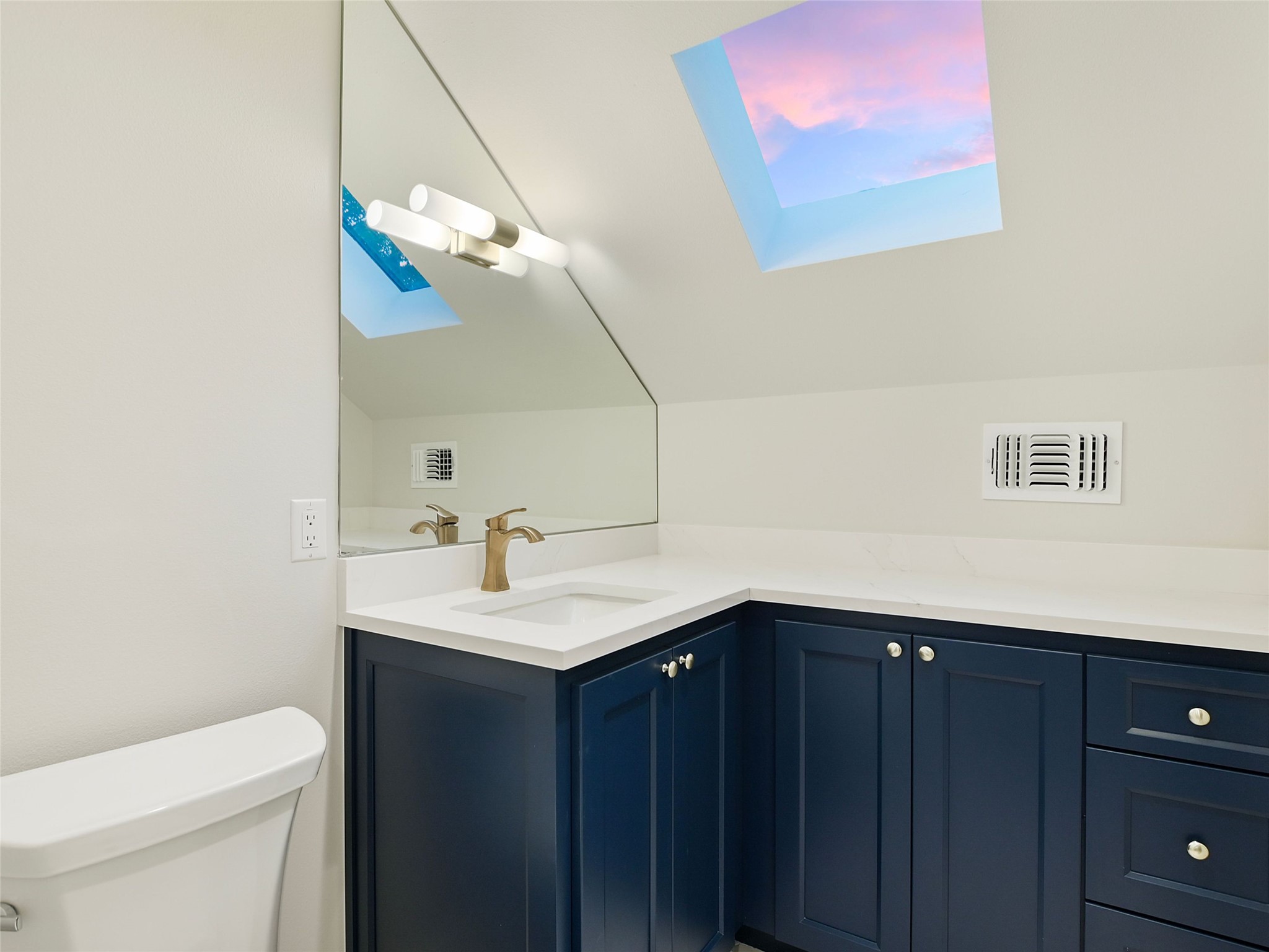 1603 Willow Street Austin, TX 78702 - Photo 24 of 30 a bathroom with a sink vanity and a mirror