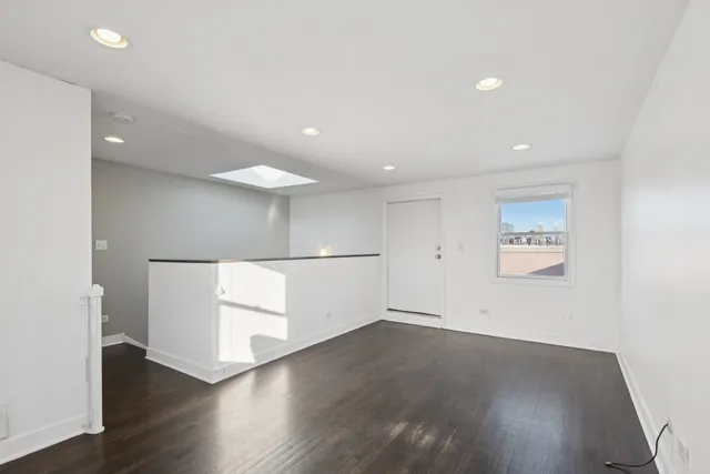 an empty room with wooden floor