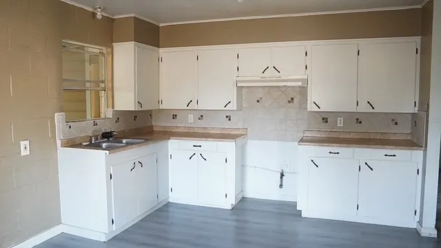 a kitchen with stainless steel appliances granite countertop a sink and cabinets