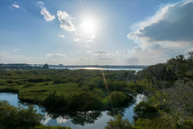 an aerial view of a houses with ocean view