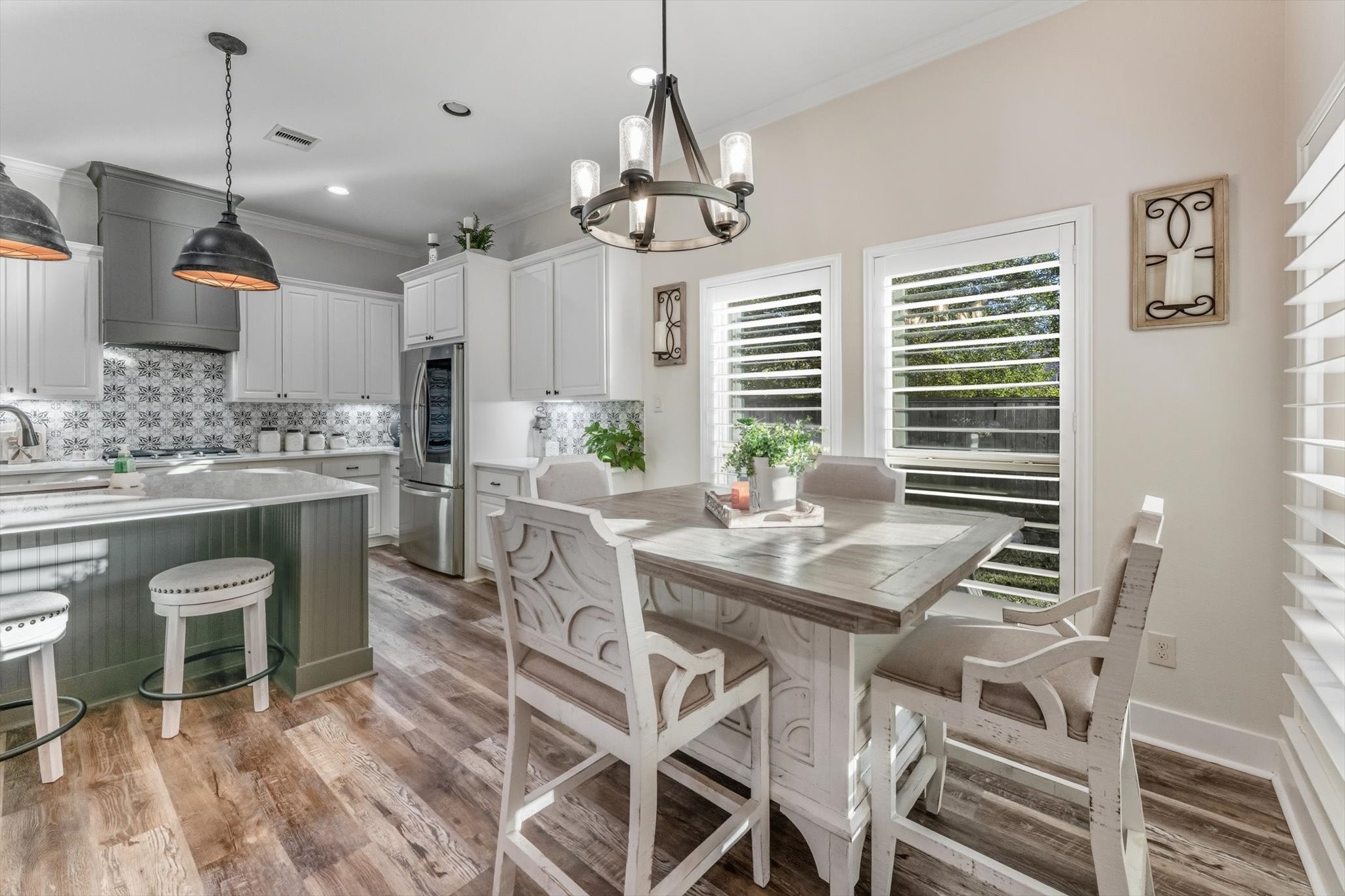 103 Fox Rindle Road Montgomery, TX 77316 - Photo 12 of 44 Spacious dining area designed for gathering, with statement lighting and seamless flow into the kitchen for effortless hosting.