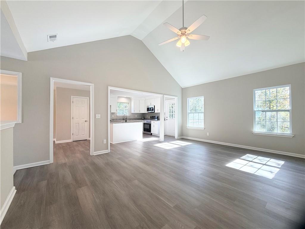 382 Arlington Lane Commerce, GA 30529 - Photo 16 of 43 a view of empty room with wooden floor and fan