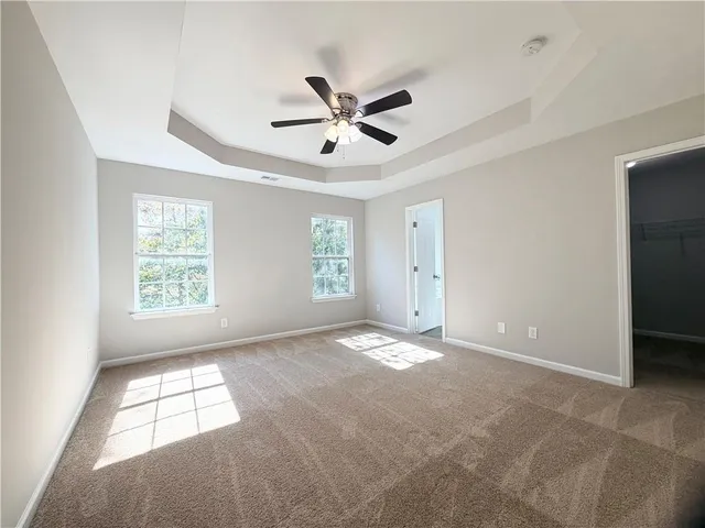a view of a livingroom with a ceiling fan and window