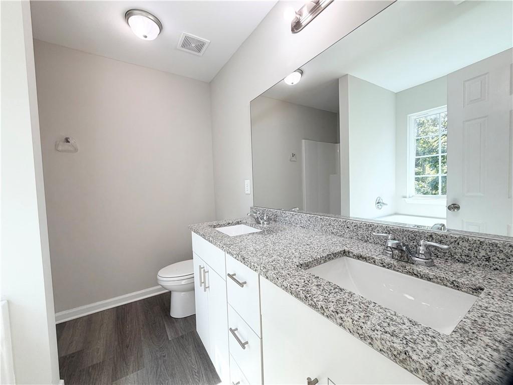 382 Arlington Lane Commerce, GA 30529 - Photo 22 of 43 a bathroom with a granite countertop sink a toilet and a granite