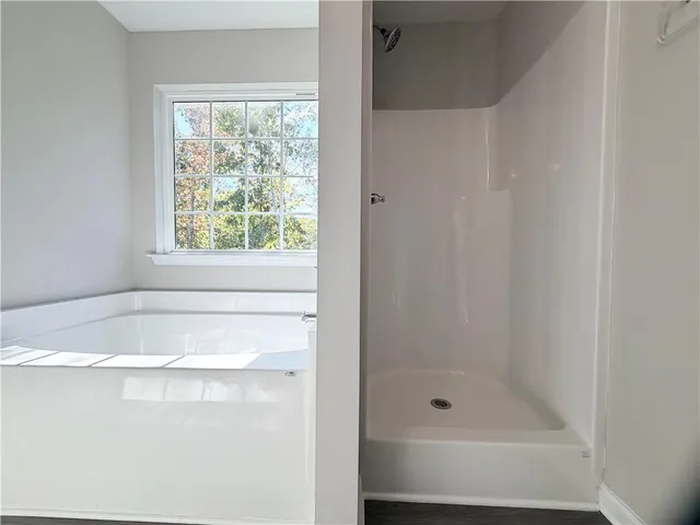 a bathroom with a granite countertop sink toilet mirror and bathtub