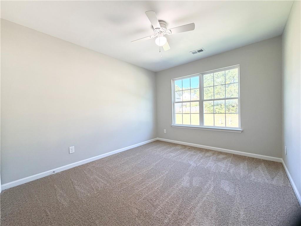 382 Arlington Lane Commerce, GA 30529 - Photo 27 of 43 an empty room with windows and ceiling fan