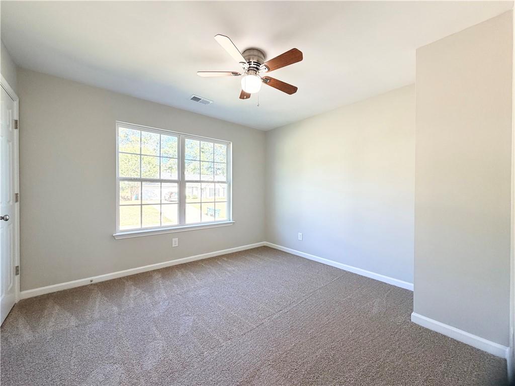 382 Arlington Lane Commerce, GA 30529 - Photo 28 of 43 an empty room with window and ceiling fan