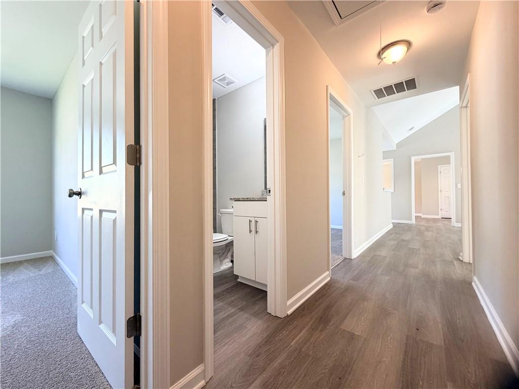 382 Arlington Lane Commerce, GA 30529 - Photo 29 of 43 a view of a hallway with wooden floor and a bathroom
