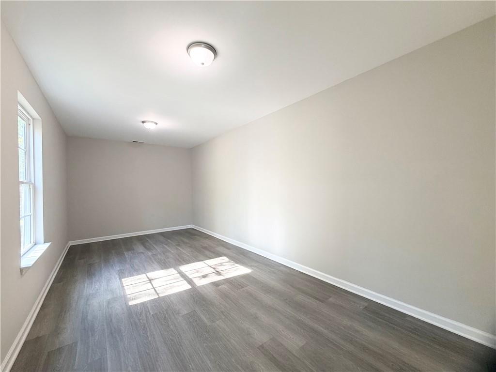 382 Arlington Lane Commerce, GA 30529 - Photo 37 of 43 an empty room with wooden floor and windows