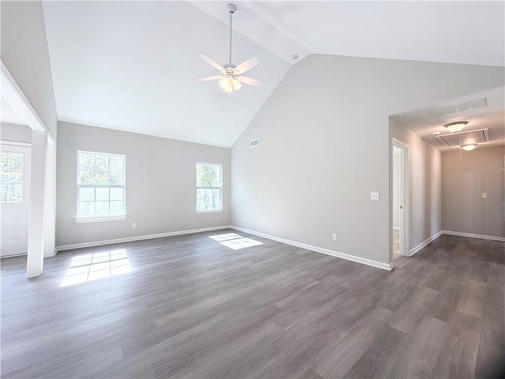 382 Arlington Lane Commerce, GA 30529 - Photo 6 of 43 an empty room with wooden floor and windows